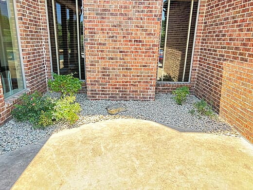 Low-Maintenance Stone Landscaping in Brick Courtyard